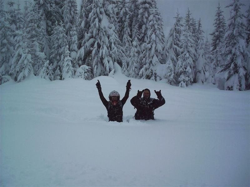 Up to their waists in snow, snowmobilers pose for a picture during a break from riding near the Pend Oreille Scenic Byway in Idaho