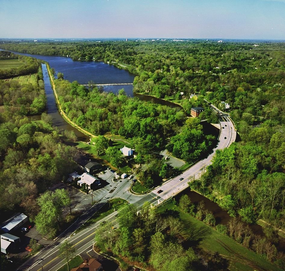An aerial view gives way to the Kingston Lock and the relationship between the canal and Millstone River-- the canal a straight line running alongside the meandering river.
