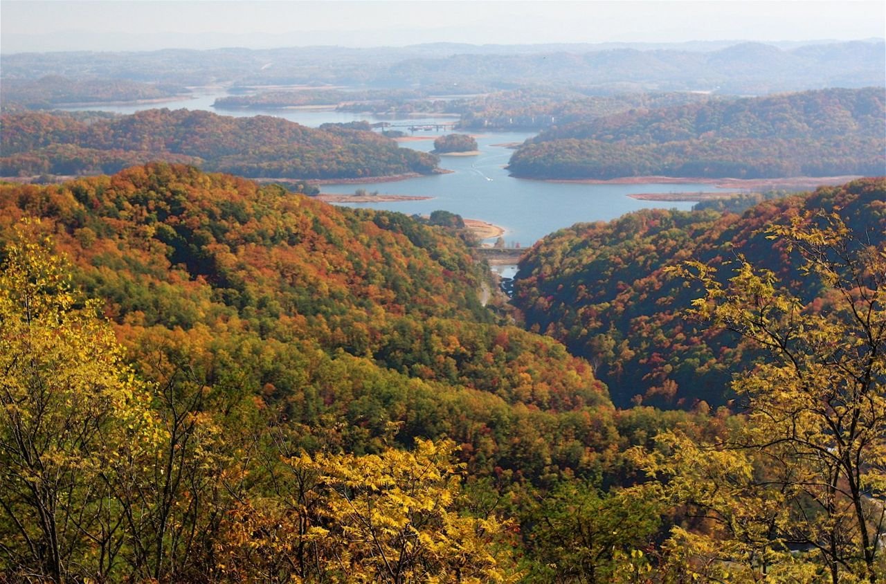 From high atop Clinch Mountain, one can see south across the forested, winding shorelines of Cherokee Lake to the misty Great Smoky Mountains in the distance, a long, serene view of a broad valley with extensive lakes stretching in all directions. This was the route and landscape through which passed the East Tennessee Crossing — the Warriors Path, the Wilderness Road, and the Dixie Highway.