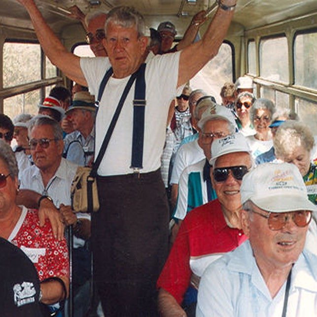 Older travelers and a guide on a group tour