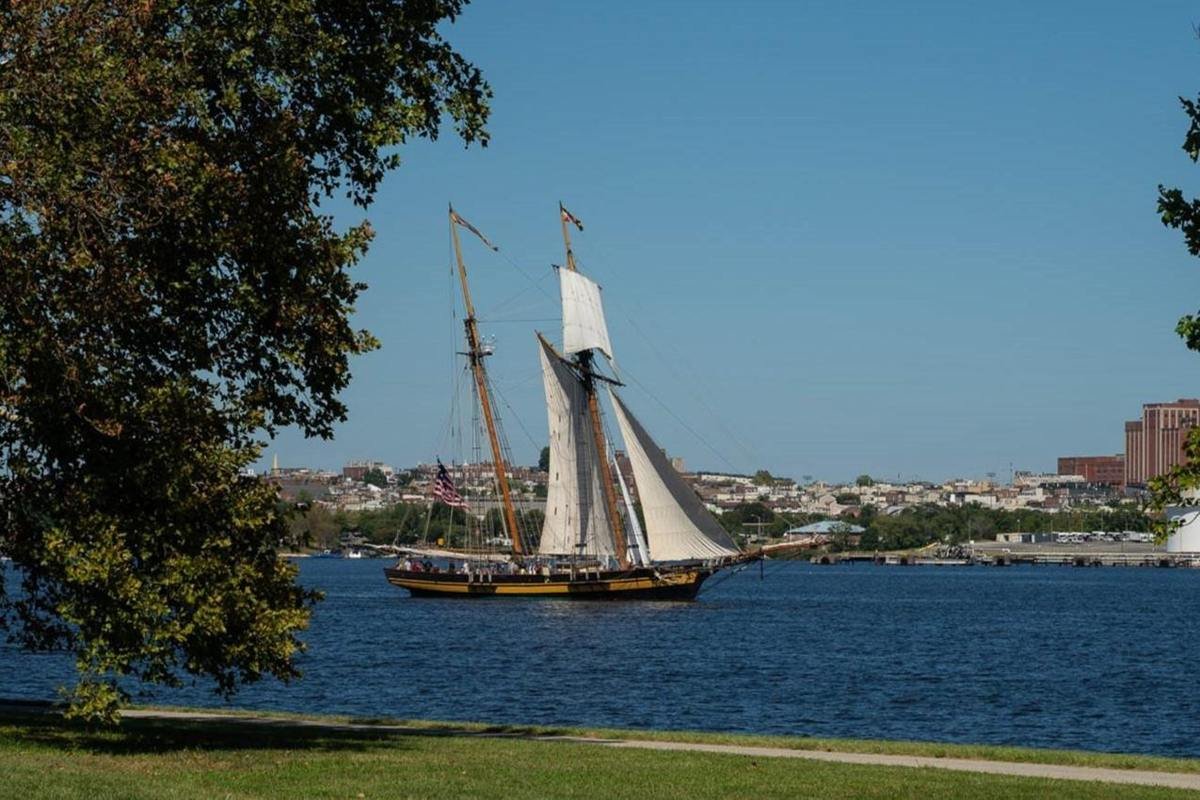 A tall ship sails on the water.