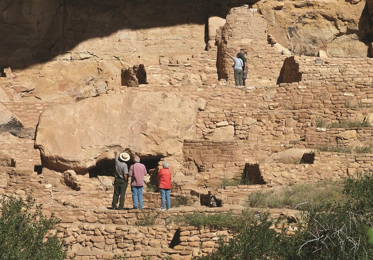 Park visitors visiting a cliff dwelling