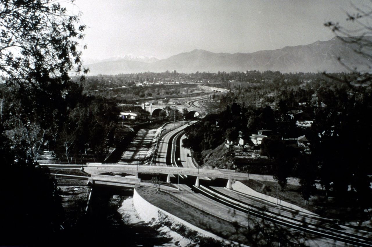 1940 view of recently opened Arroyo Seco Parkway featuring Avenue 64 and York Street bridges with a view to the San Gabriel mountains.